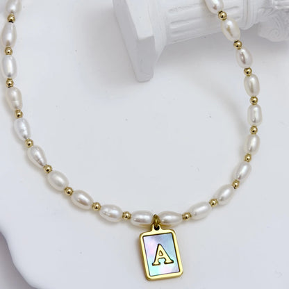 Premium freshwater rice pearl and 14K gold filled beaded necklace with personalised blue mother of shell initial charm, hand-finished in Australia