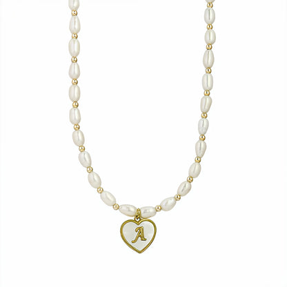 Premium freshwater rice pearl and 14K gold filled beaded necklace with personalised heart shaped mother of shell initial charm, hand-finished in Australia