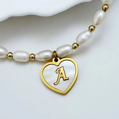 Premium freshwater rice pearl and 14K gold filled beaded necklace with personalised heart shaped mother of shell initial charm, hand-finished in Australia