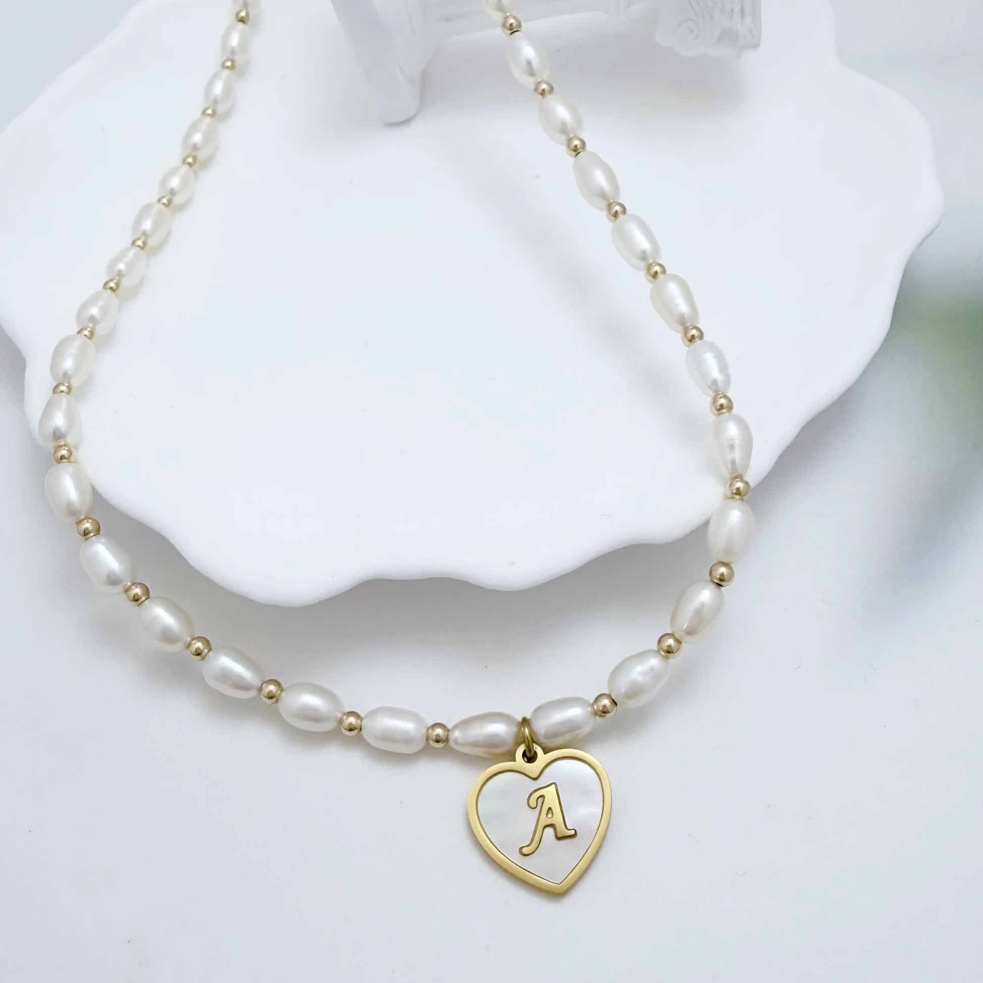 Premium freshwater rice pearl and 14K gold filled beaded necklace with personalised heart shaped mother of shell initial charm, hand-finished in Australia