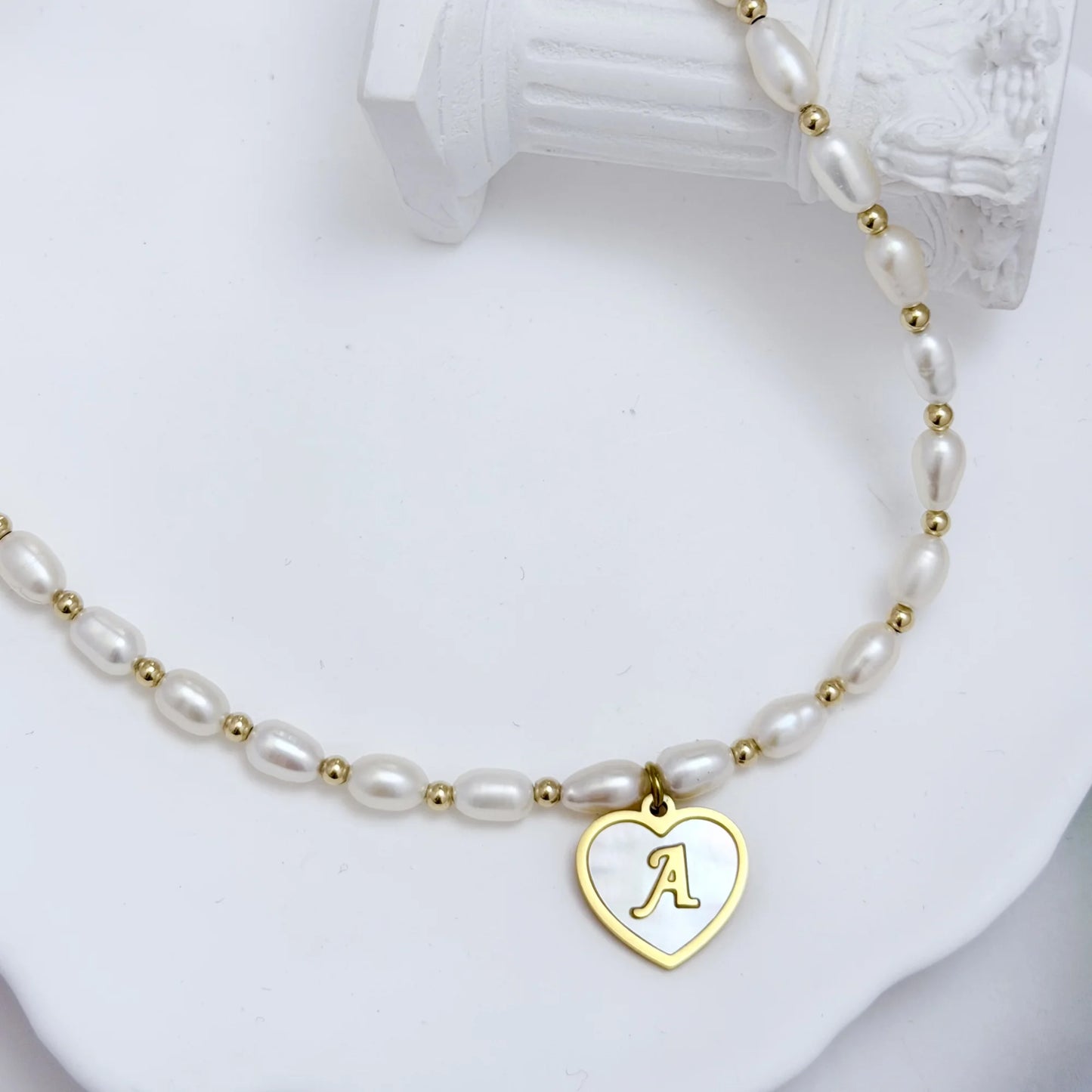 Premium freshwater rice pearl and 14K gold filled beaded necklace with personalised heart shaped mother of shell initial charm, hand-finished in Australia