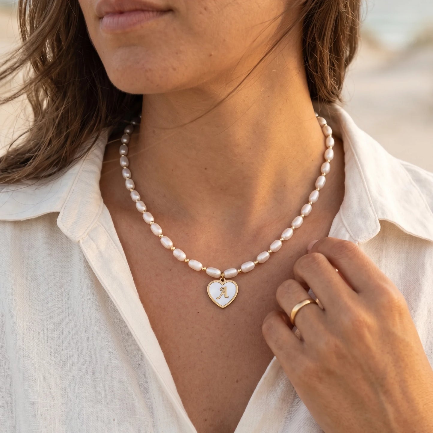 Premium freshwater rice pearl and 14K gold filled beaded necklace with personalised heart shaped mother of shell initial charm, hand-finished in Australia