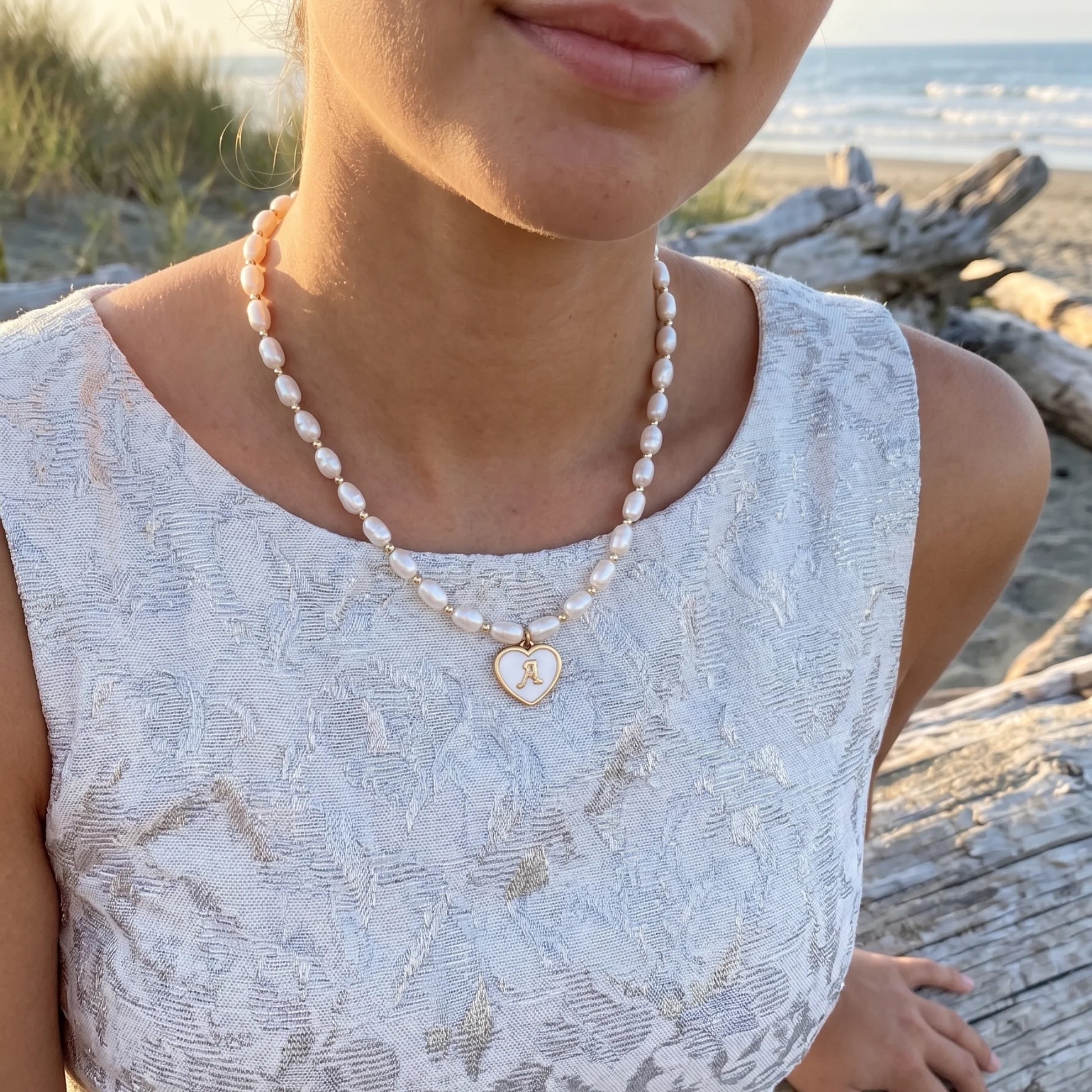 Premium freshwater rice pearl and 14K gold filled beaded necklace with personalised heart shaped mother of shell initial charm, hand-finished in Australia