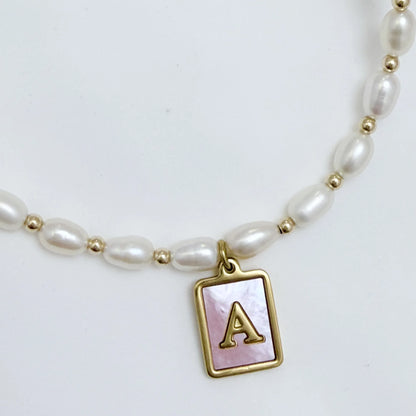 Premium freshwater rice pearl and 14K gold filled beaded necklace with personalised pink mother of shell initial charm, hand-finished in Australia