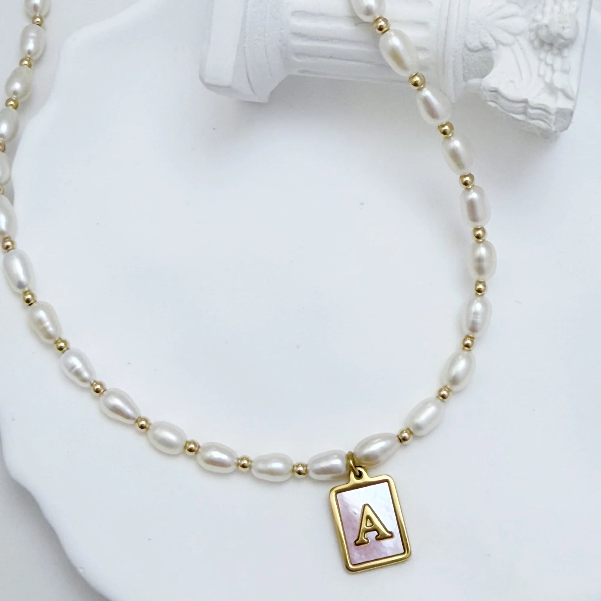 Premium freshwater rice pearl and 14K gold filled beaded necklace with personalised pink mother of shell initial charm, hand-finished in Australia