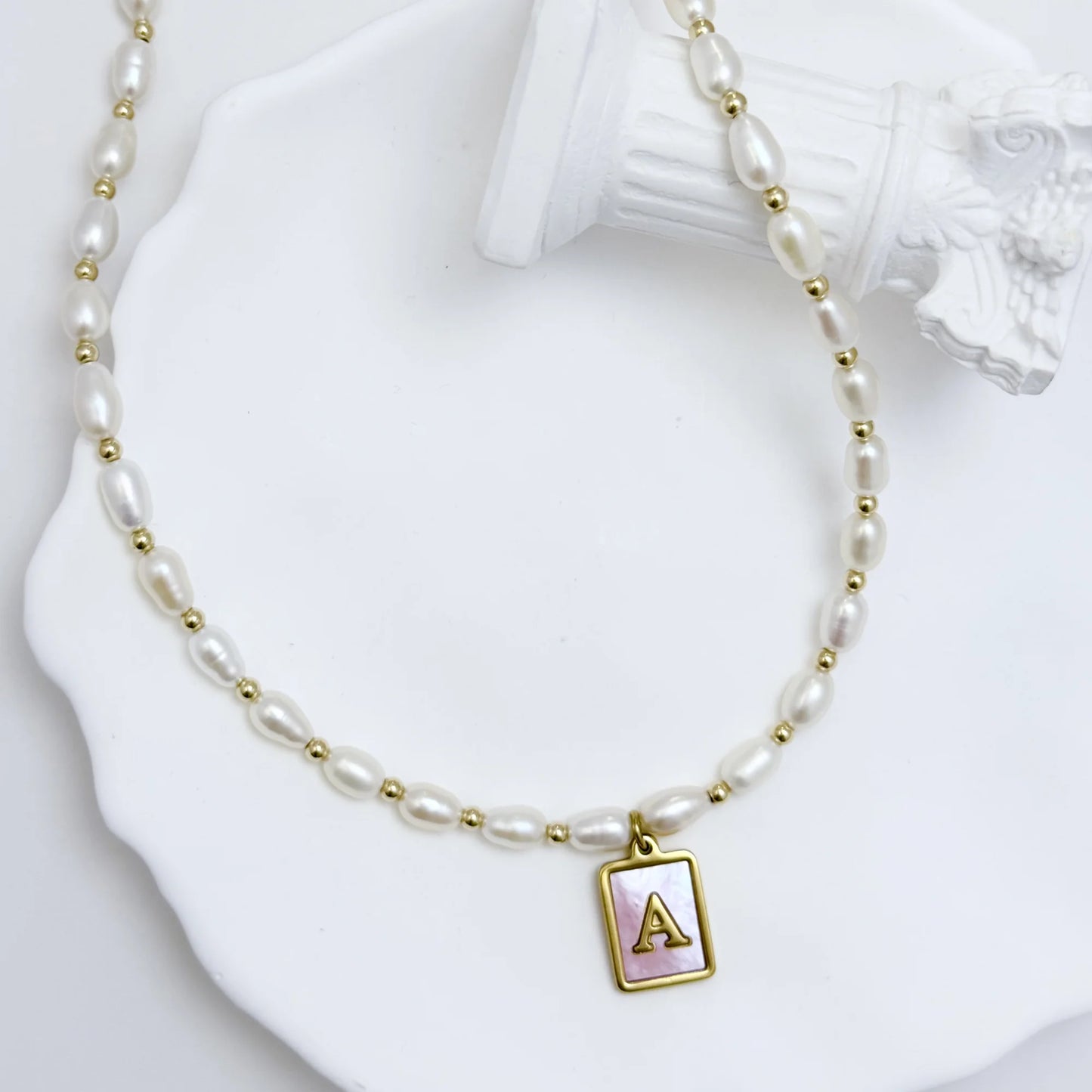 Premium freshwater rice pearl and 14K gold filled beaded necklace with personalised pink mother of shell initial charm, hand-finished in Australia