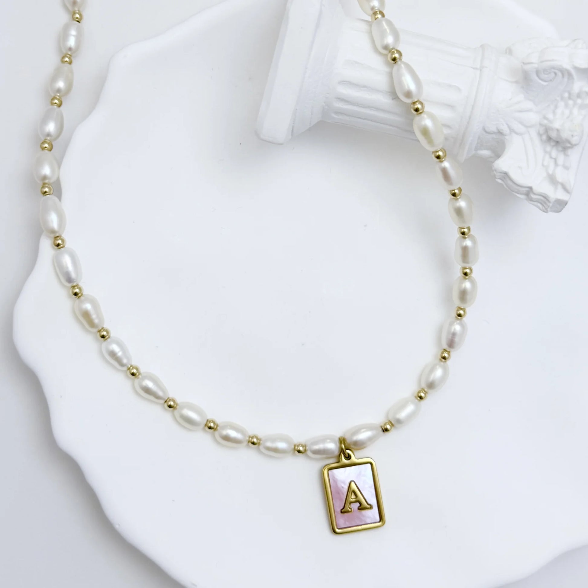 Premium freshwater rice pearl and 14K gold filled beaded necklace with personalised pink mother of shell initial charm, hand-finished in Australia
