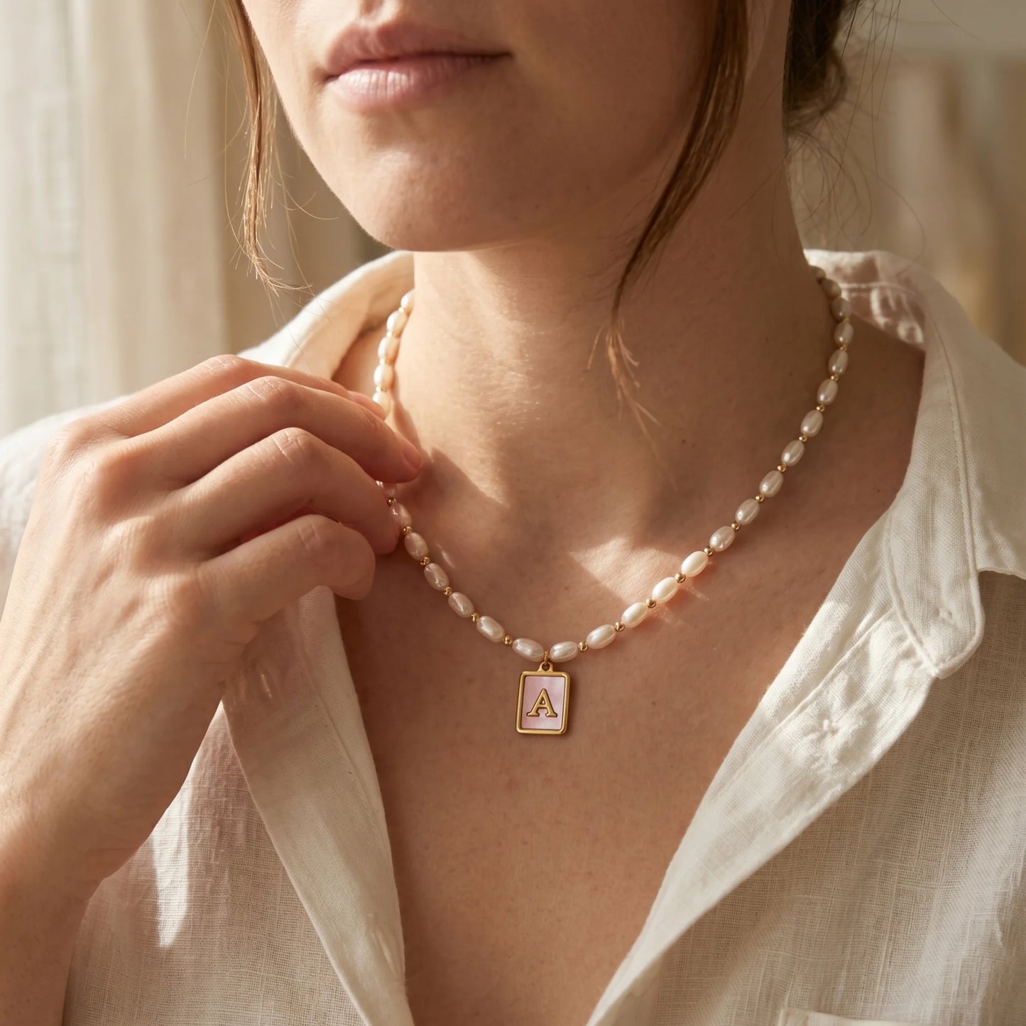 Premium freshwater rice pearl and 14K gold filled beaded necklace with personalised pink mother of shell initial charm, hand-finished in Australia