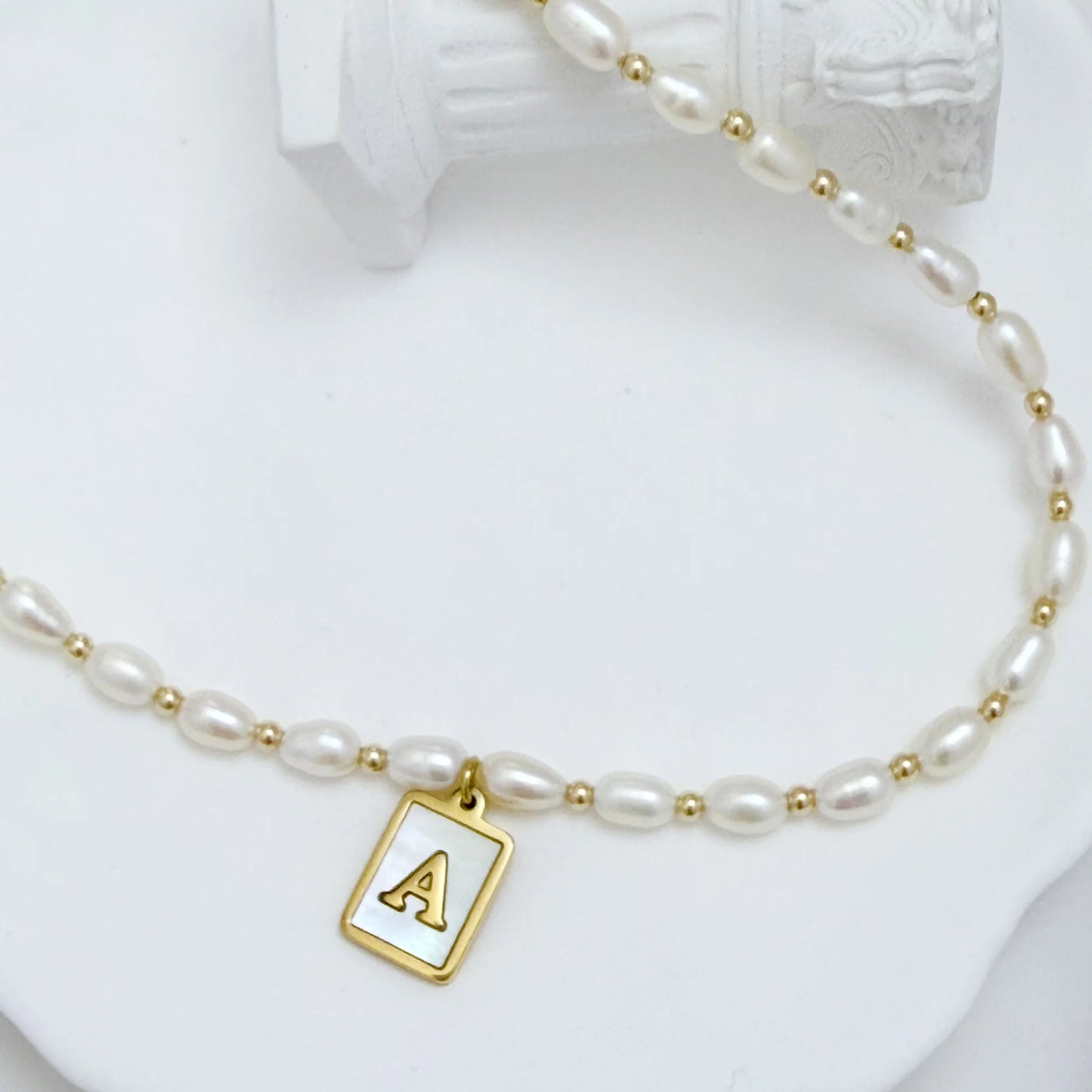 Premium freshwater rice pearl and 14K gold filled beaded necklace with personalised mother of shell initial charm, hand-finished in Australia