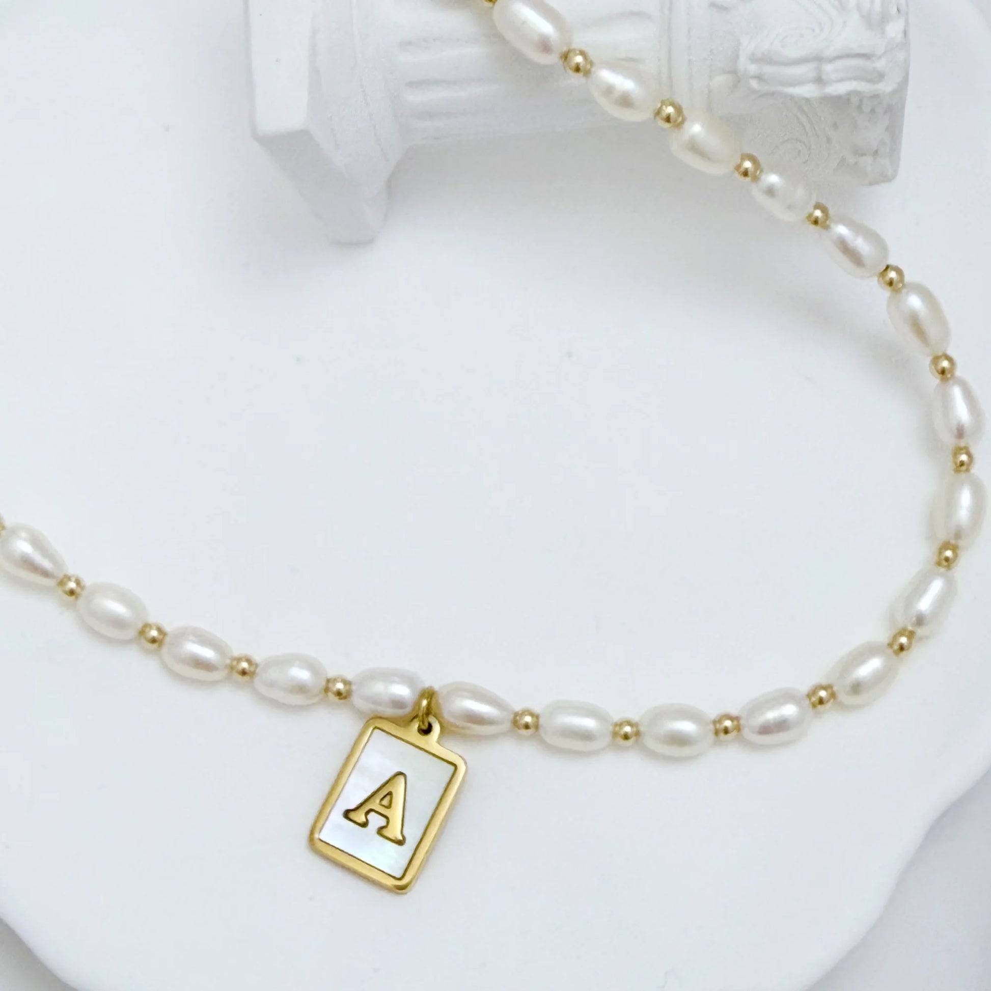 Premium freshwater rice pearl and 14K gold filled beaded necklace with personalised mother of shell initial charm, hand-finished in Australia