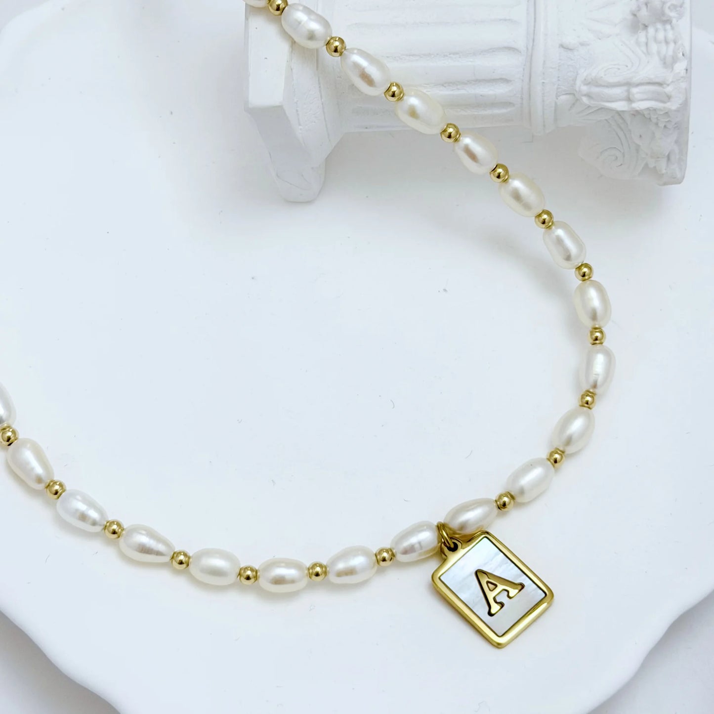 Premium freshwater rice pearl and 14K gold filled beaded necklace with personalised mother of shell initial charm, hand-finished in Australia