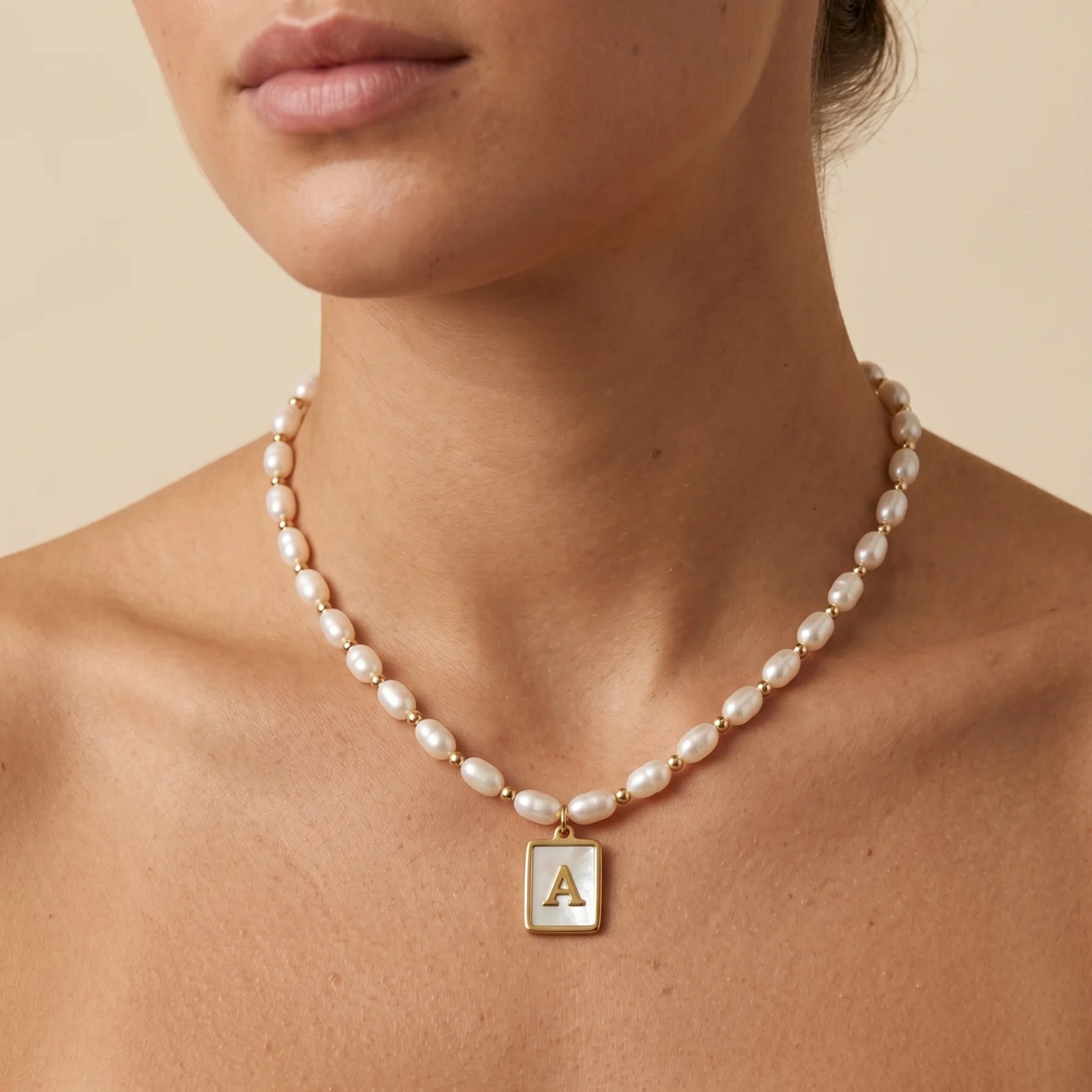 Premium freshwater rice pearl and 14K gold filled beaded necklace with personalised mother of shell initial charm, hand-finished in Australia