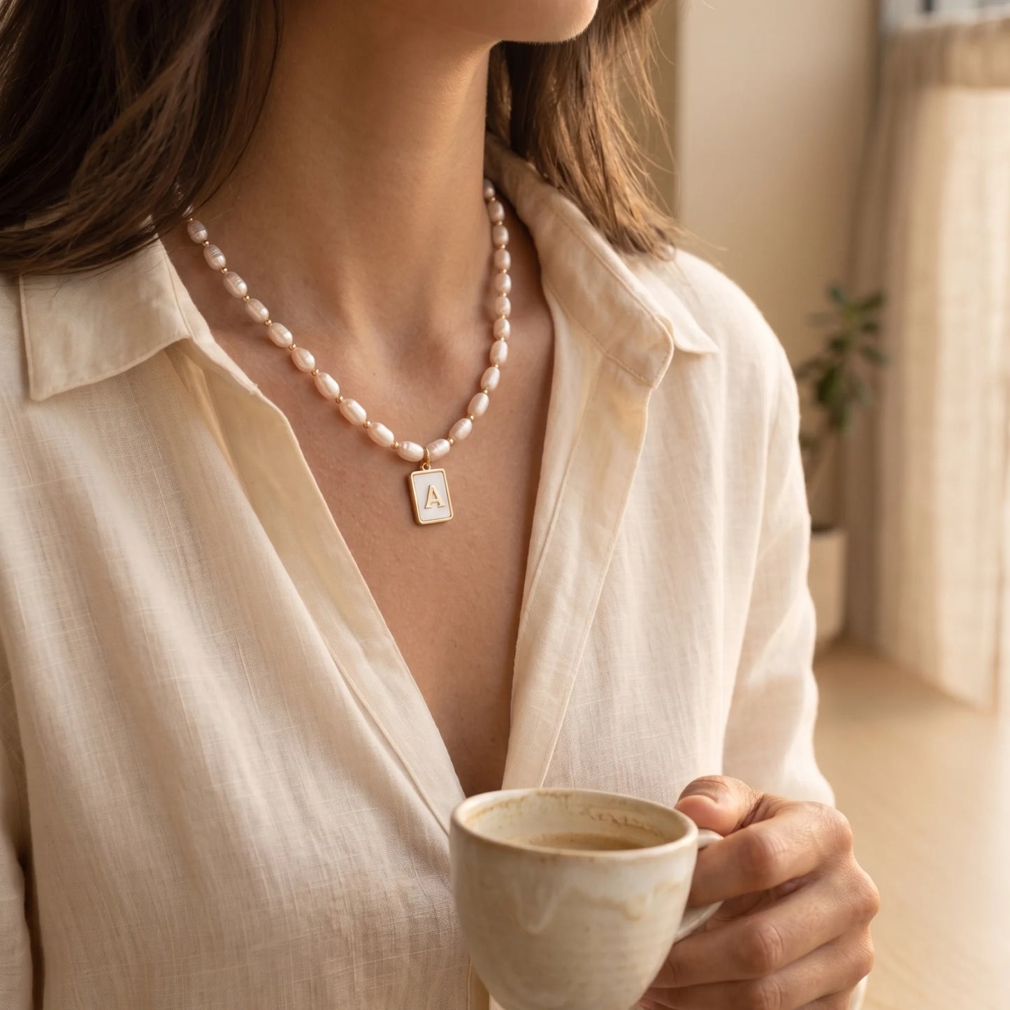 Premium freshwater rice pearl and 14K gold filled beaded necklace with personalised mother of shell initial charm, hand-finished in Australia
