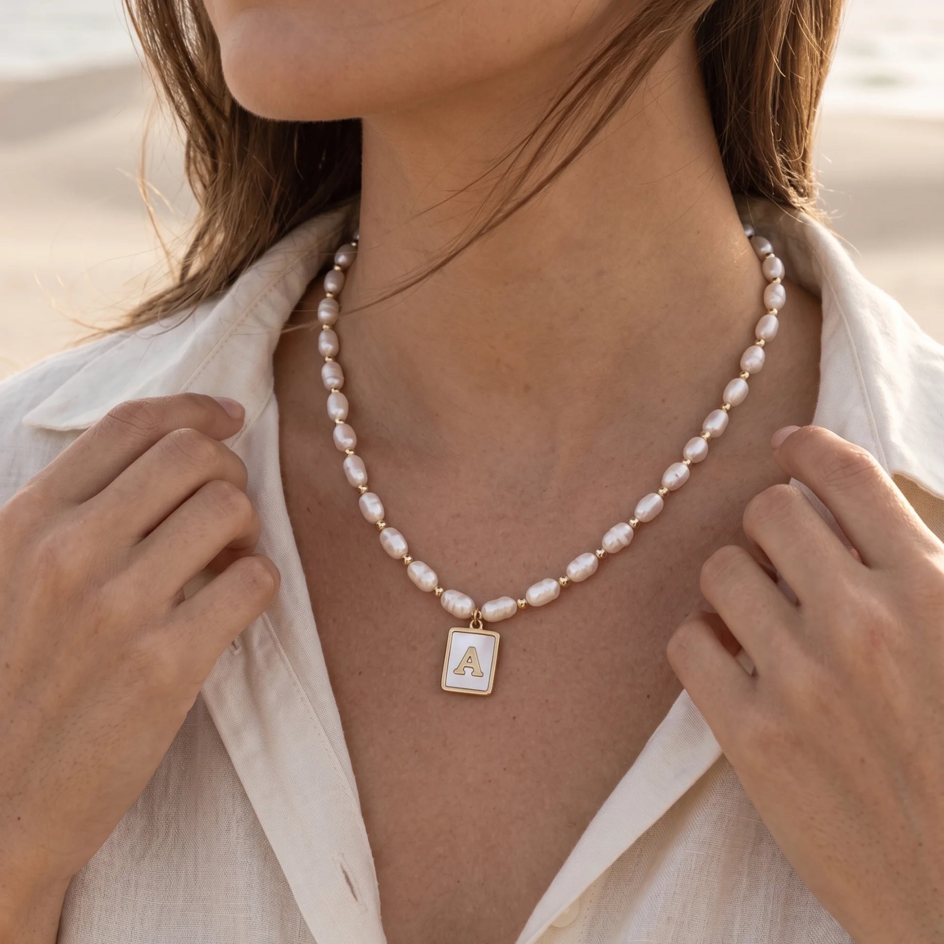 Premium freshwater rice pearl and 14K gold filled beaded necklace with personalised mother of shell initial charm, hand-finished in Australia