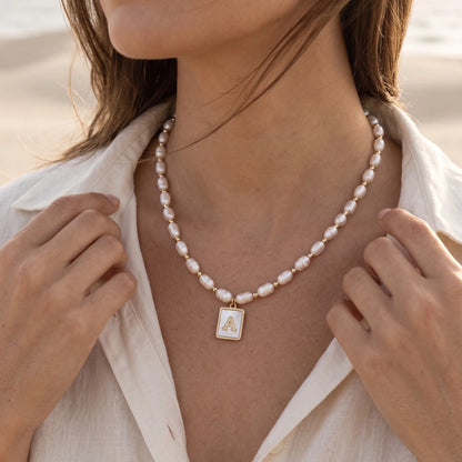 Premium freshwater rice pearl and 14K gold filled beaded necklace with personalised mother of shell initial charm, hand-finished in Australia