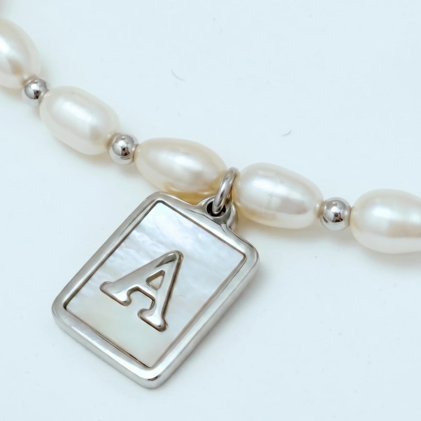 Premium freshwater rice pearl and 925 sterling silver beaded necklace with personalised mother of shell initial charm, hand-finished in Australia