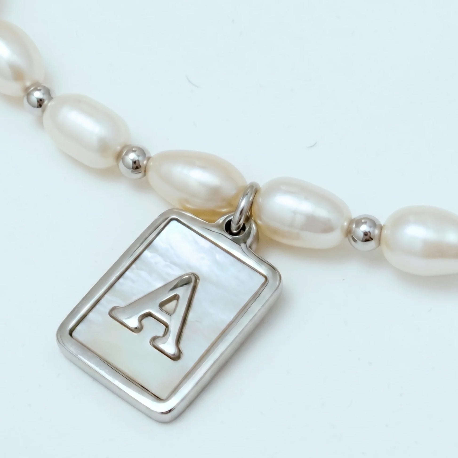 Premium freshwater rice pearl and 925 sterling silver beaded necklace with personalised mother of shell initial charm, hand-finished in Australia