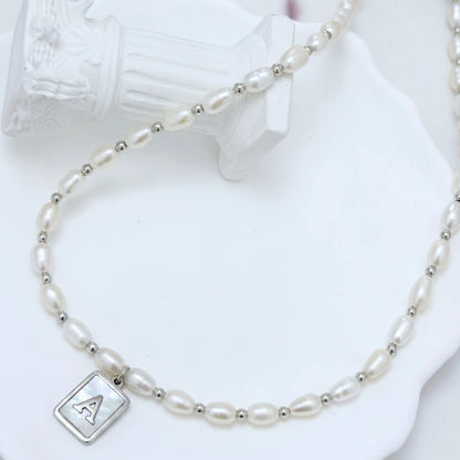 Premium freshwater rice pearl and 925 sterling silver beaded necklace with personalised mother of shell initial charm, hand-finished in Australia