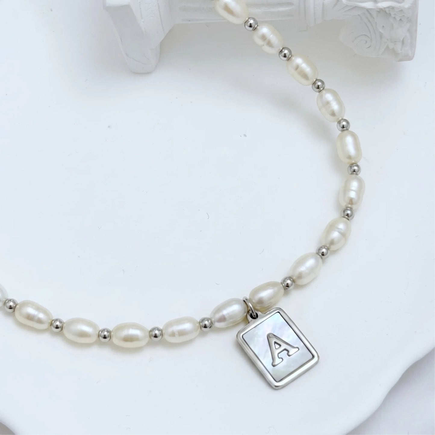 Premium freshwater rice pearl and 925 sterling silver beaded necklace with personalised mother of shell initial charm, hand-finished in Australia