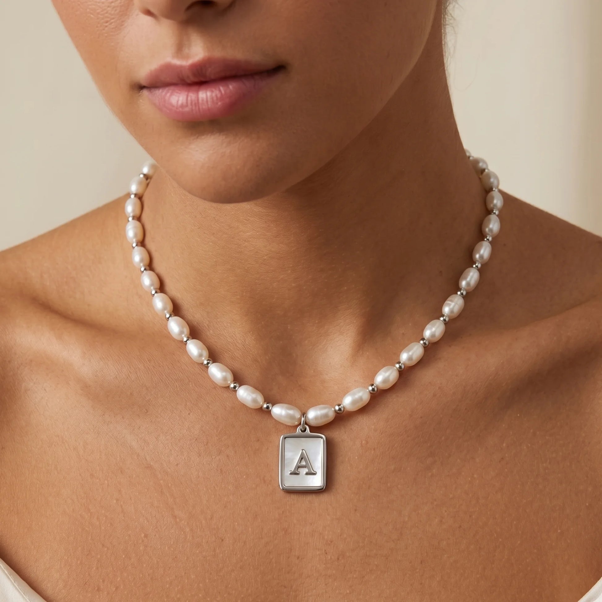 Premium freshwater rice pearl and 925 sterling silver beaded necklace with personalised mother of shell initial charm, hand-finished in Australia