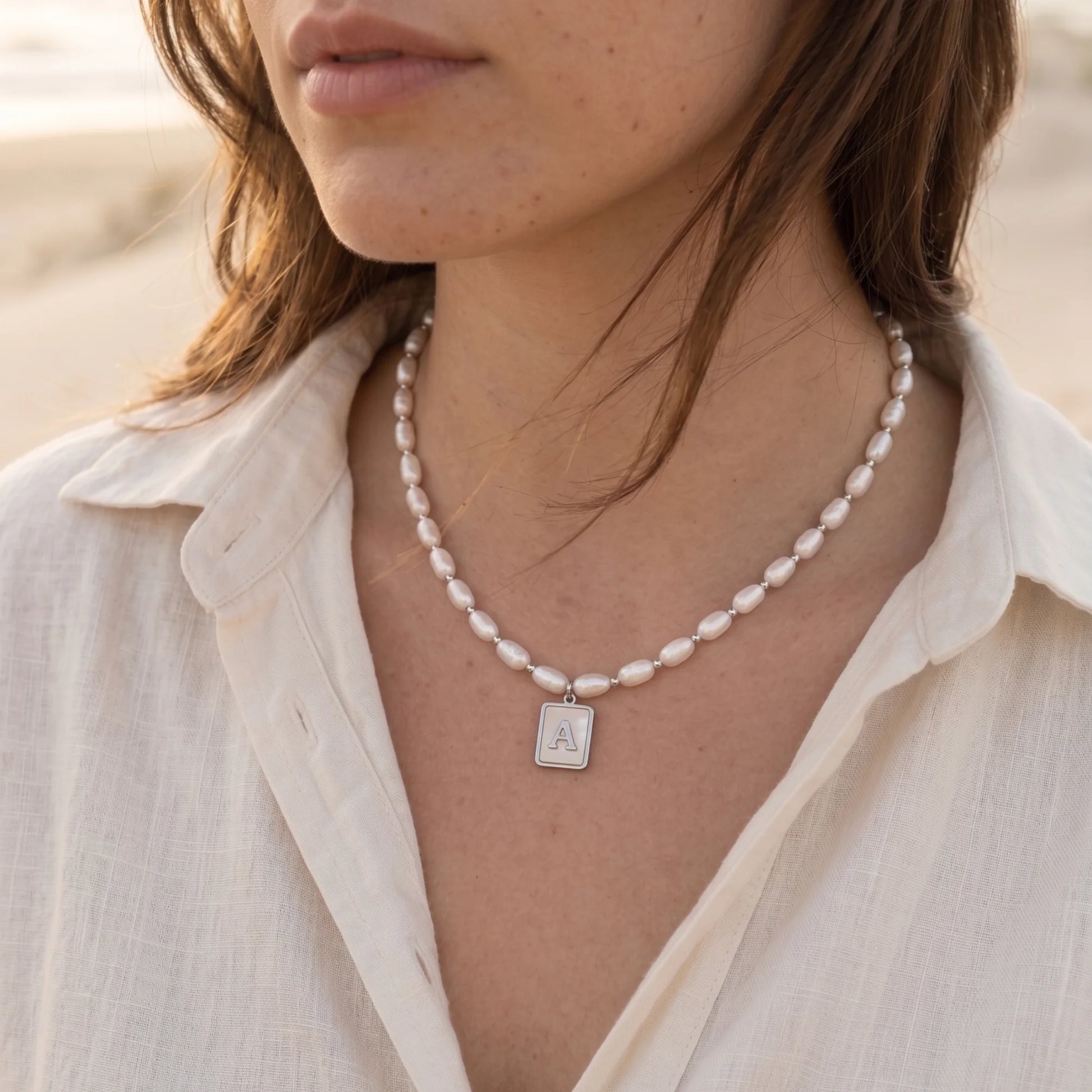 Premium freshwater rice pearl and 925 sterling silver beaded necklace with personalised mother of shell initial charm, hand-finished in Australia