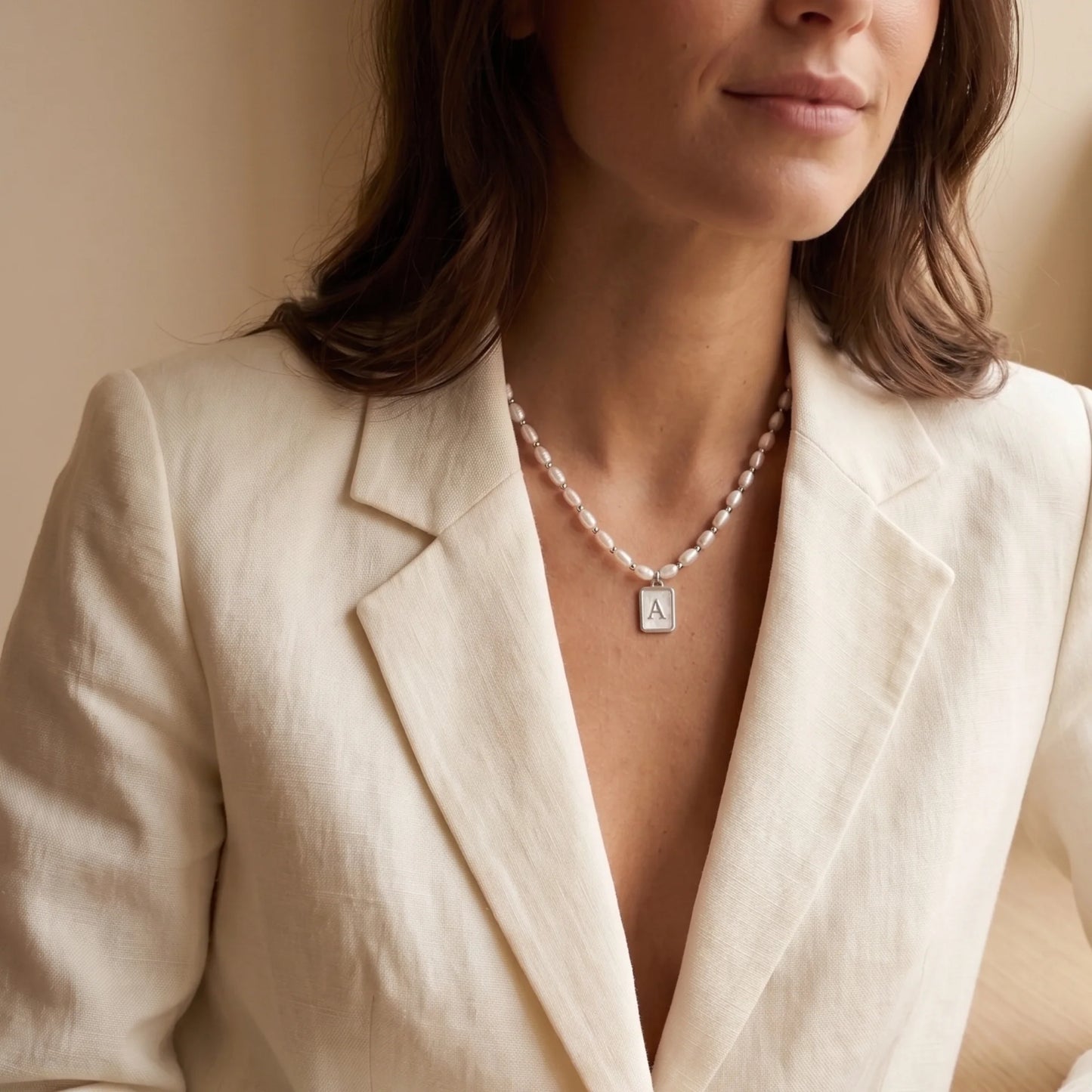 Premium freshwater rice pearl and 925 sterling silver beaded necklace with personalised mother of shell initial charm, hand-finished in Australia