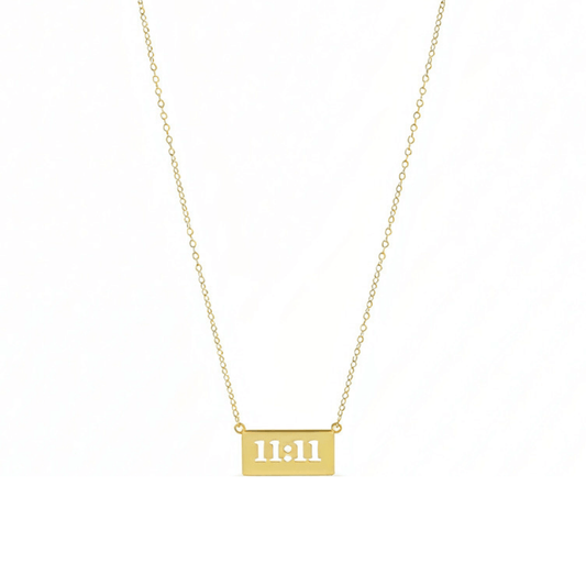 Gold 11:11 angel number necklace featuring a rectangular pendant on a dainty chain, symbolising manifestation and alignment.