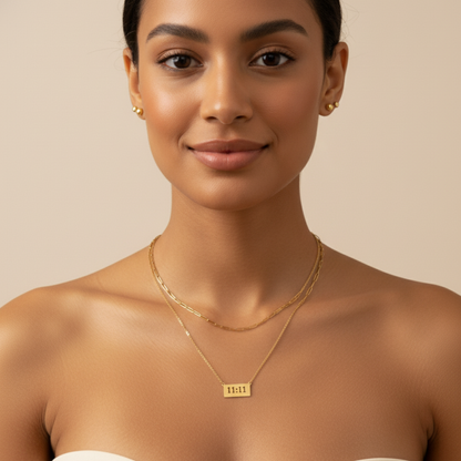 Gold 11:11 angel number necklace featuring a rectangular pendant on a dainty chain, symbolising manifestation and alignment.