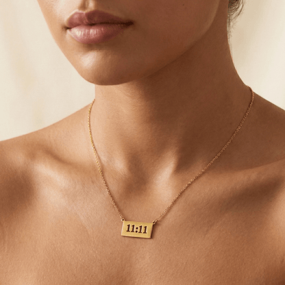 Gold 11:11 angel number necklace featuring a rectangular pendant on a dainty chain, symbolising manifestation and alignment.