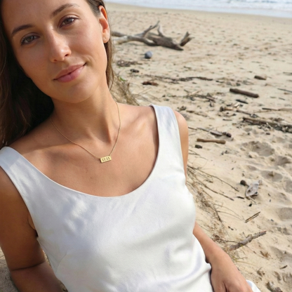 Gold 11:11 angel number necklace featuring a rectangular pendant on a dainty chain, symbolising manifestation and alignment.