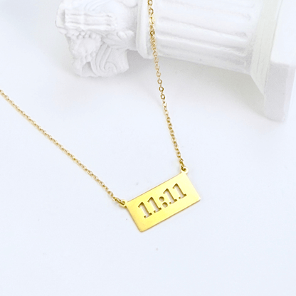 Gold 11:11 angel number necklace featuring a rectangular pendant on a dainty chain, symbolising manifestation and alignment.