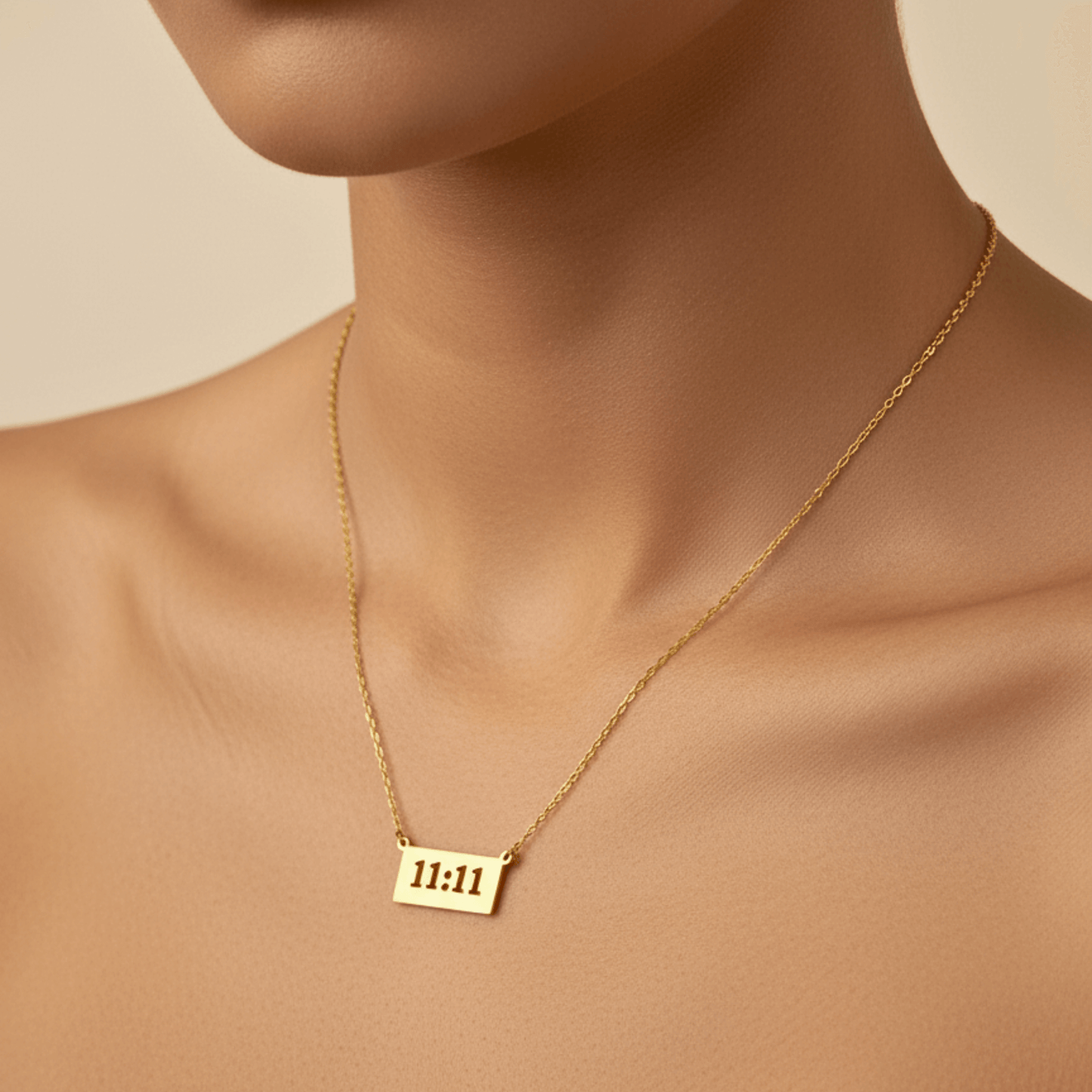 Gold 11:11 angel number necklace featuring a rectangular pendant on a dainty chain, symbolising manifestation and alignment.