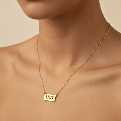 Gold 11:11 angel number necklace featuring a rectangular pendant on a dainty chain, symbolising manifestation and alignment.