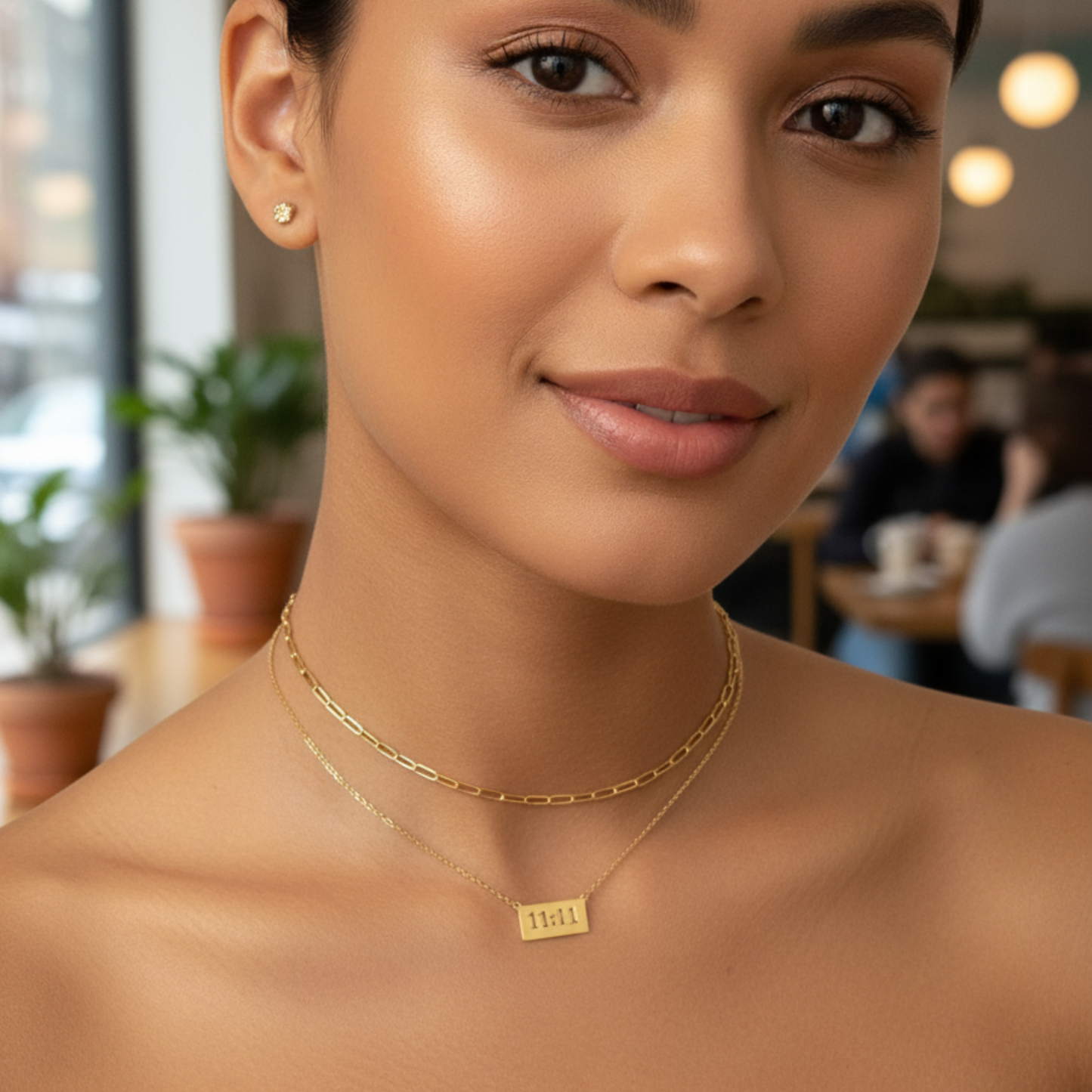 Gold 11:11 angel number necklace featuring a rectangular pendant on a dainty chain, symbolising manifestation and alignment.