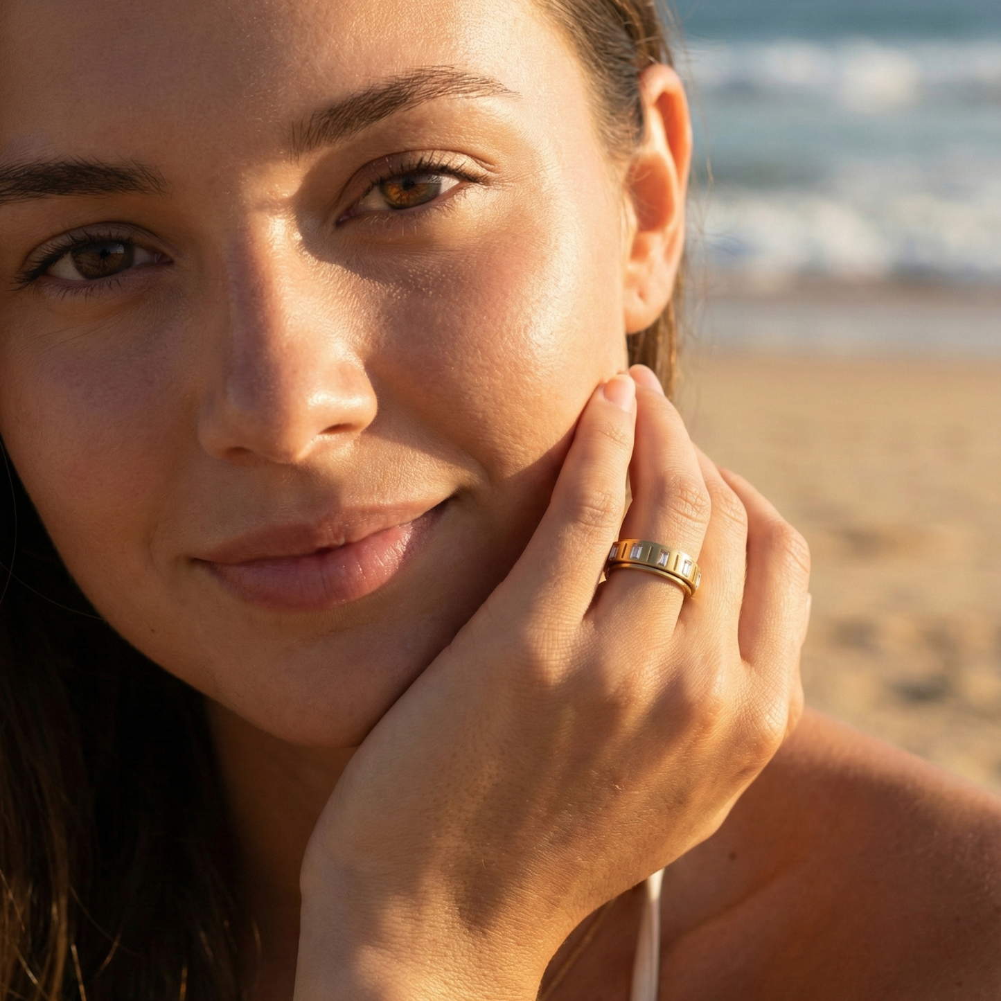 Gold Baguette Spinner Ring by MXW Jewellery featuring a rotating band set with clear rectangular crystals.