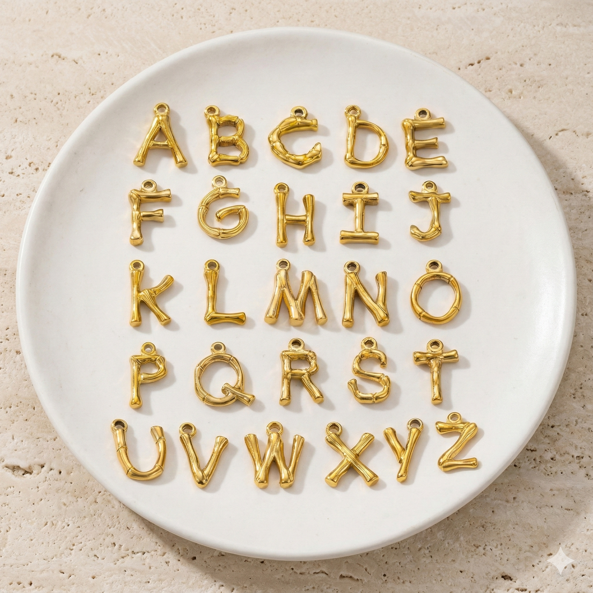 A delicate necklace made of irregular white keshi pearls featuring a gold-toned textured initial pendant in the shape of the letter A.