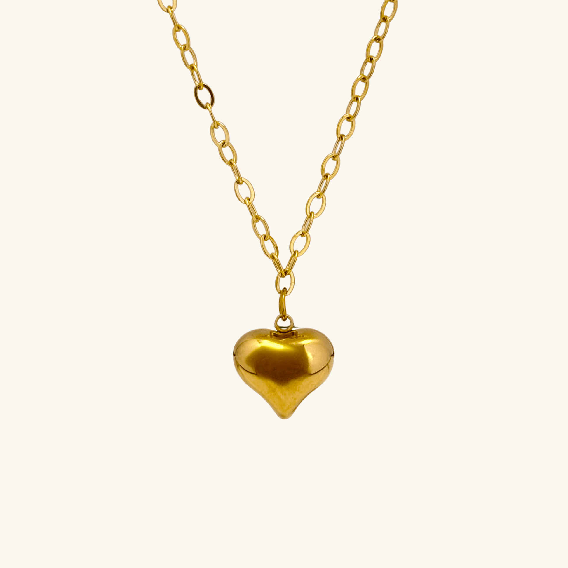 Gold chunky heart pendant necklace on model, waterproof and bold statement design