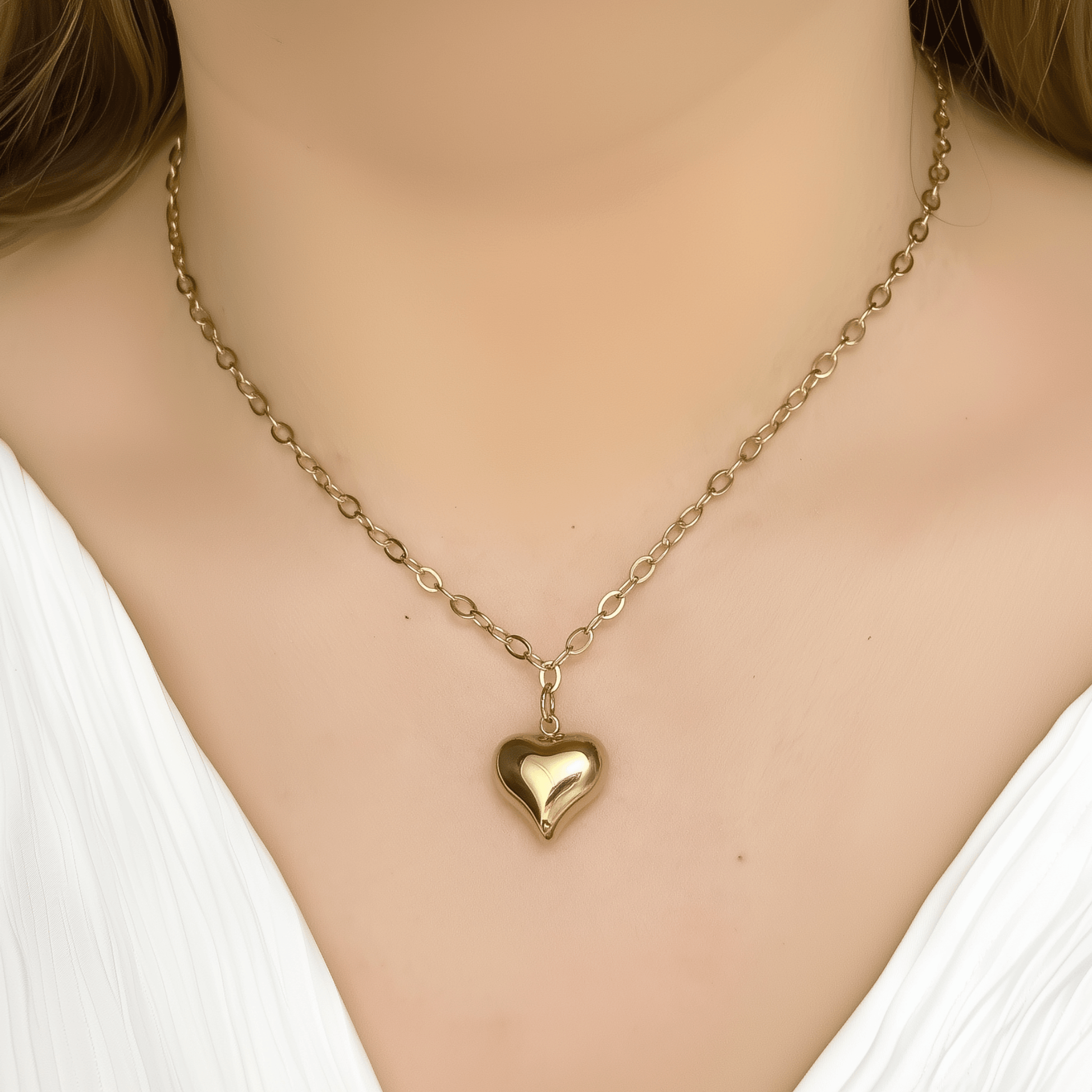 Gold chunky heart pendant necklace on model, waterproof and bold statement design