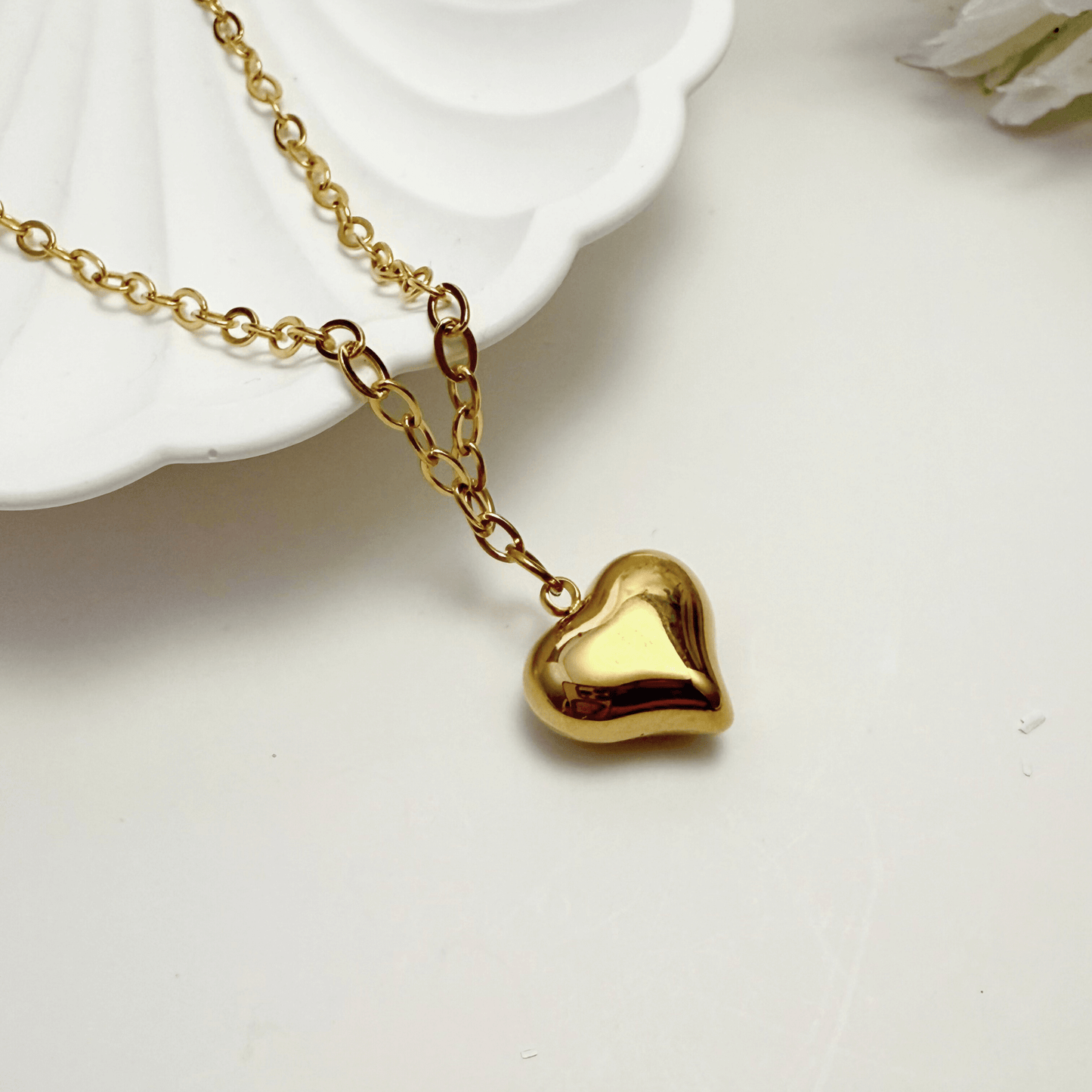 Gold chunky heart pendant necklace on model, waterproof and bold statement design