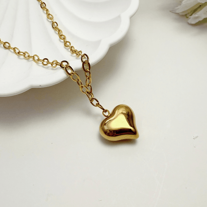 Gold chunky heart pendant necklace on model, waterproof and bold statement design