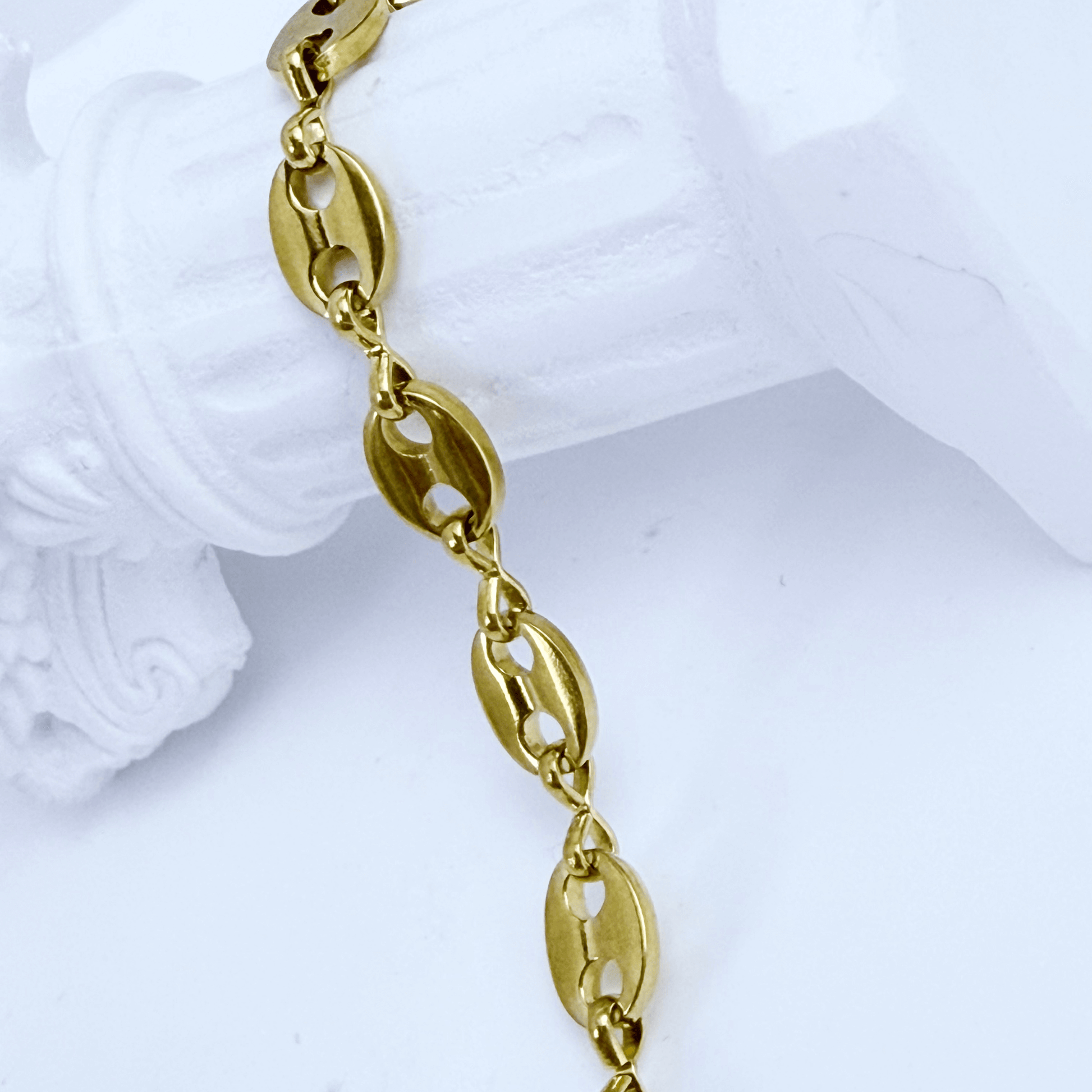 Gold coffee bean chain bracelet with sculpted oval links.