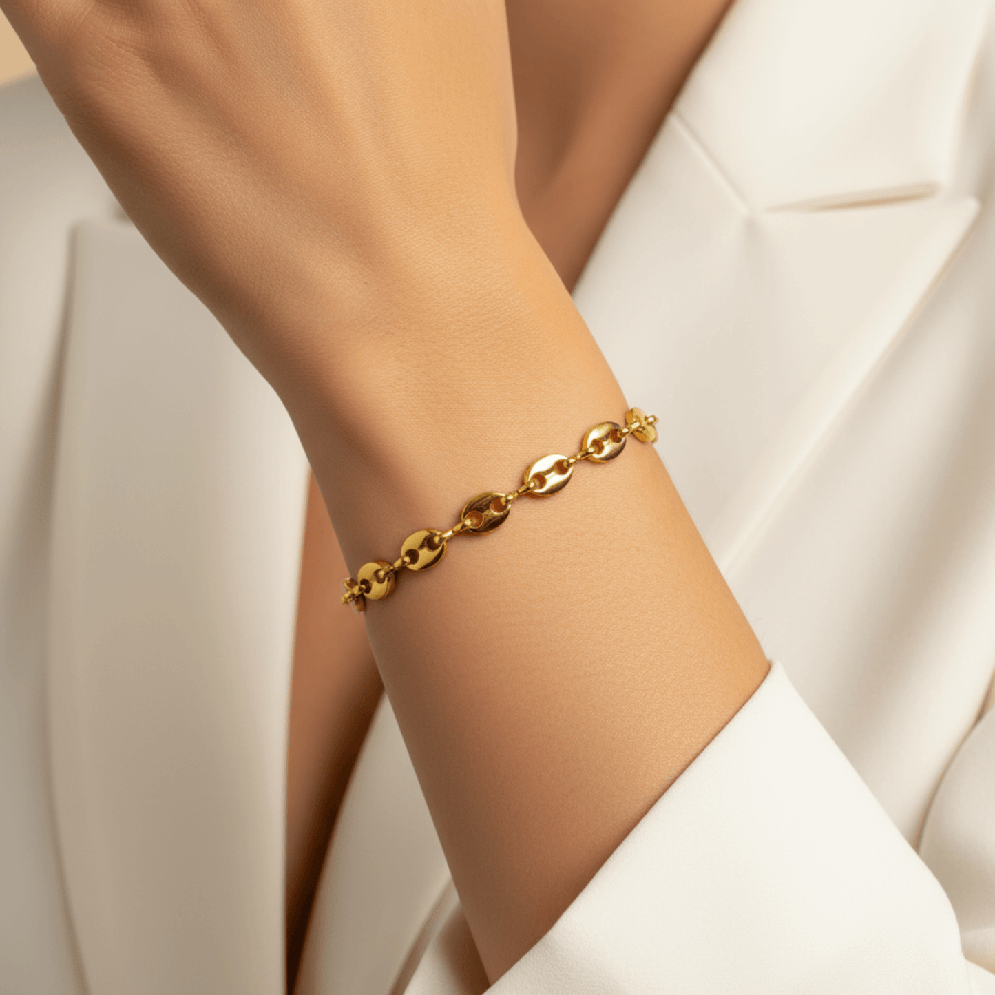 Gold coffee bean chain bracelet with sculpted oval links.