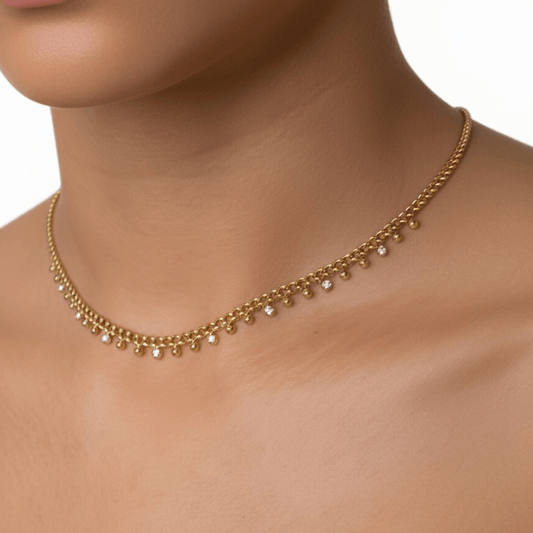 Elegant gold necklace featuring a cable chain adorned with zircon charms and gold beads, crafted from gold-plated stainless steel for a timeless and sophisticated look.