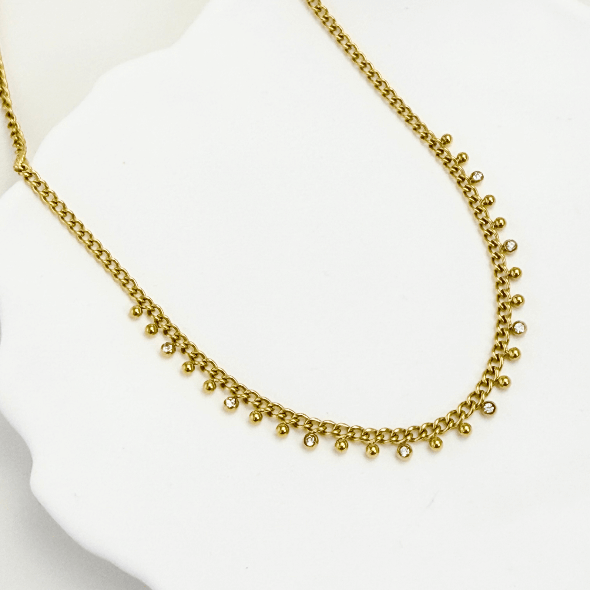 Elegant gold necklace featuring dotted zircon charms on a fine waterproof chain