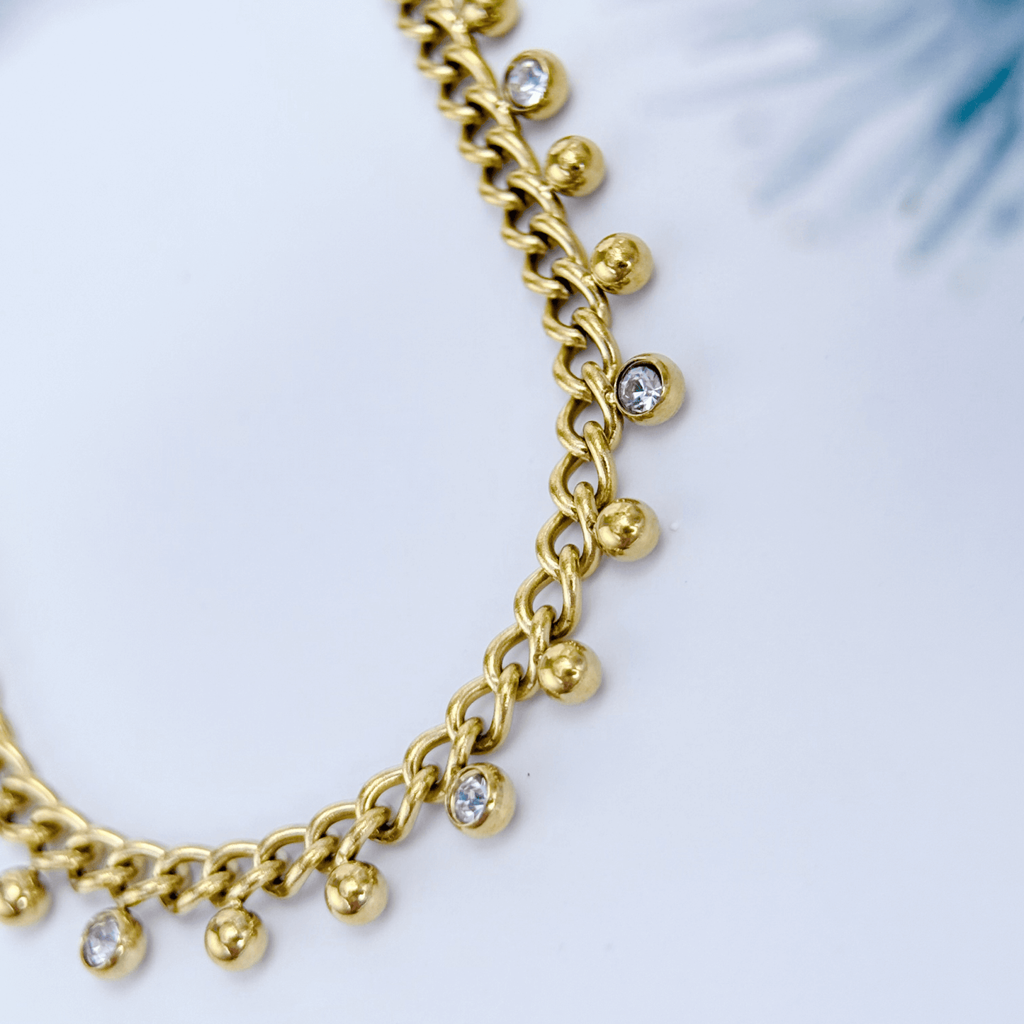 Elegant gold necklace featuring dotted zircon charms on a fine waterproof chain
