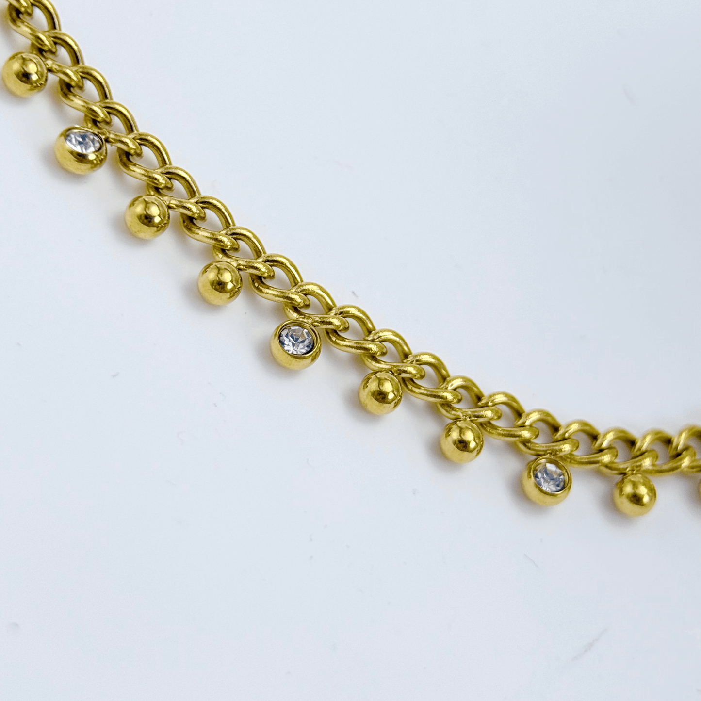 Elegant gold necklace featuring dotted zircon charms on a fine waterproof chain