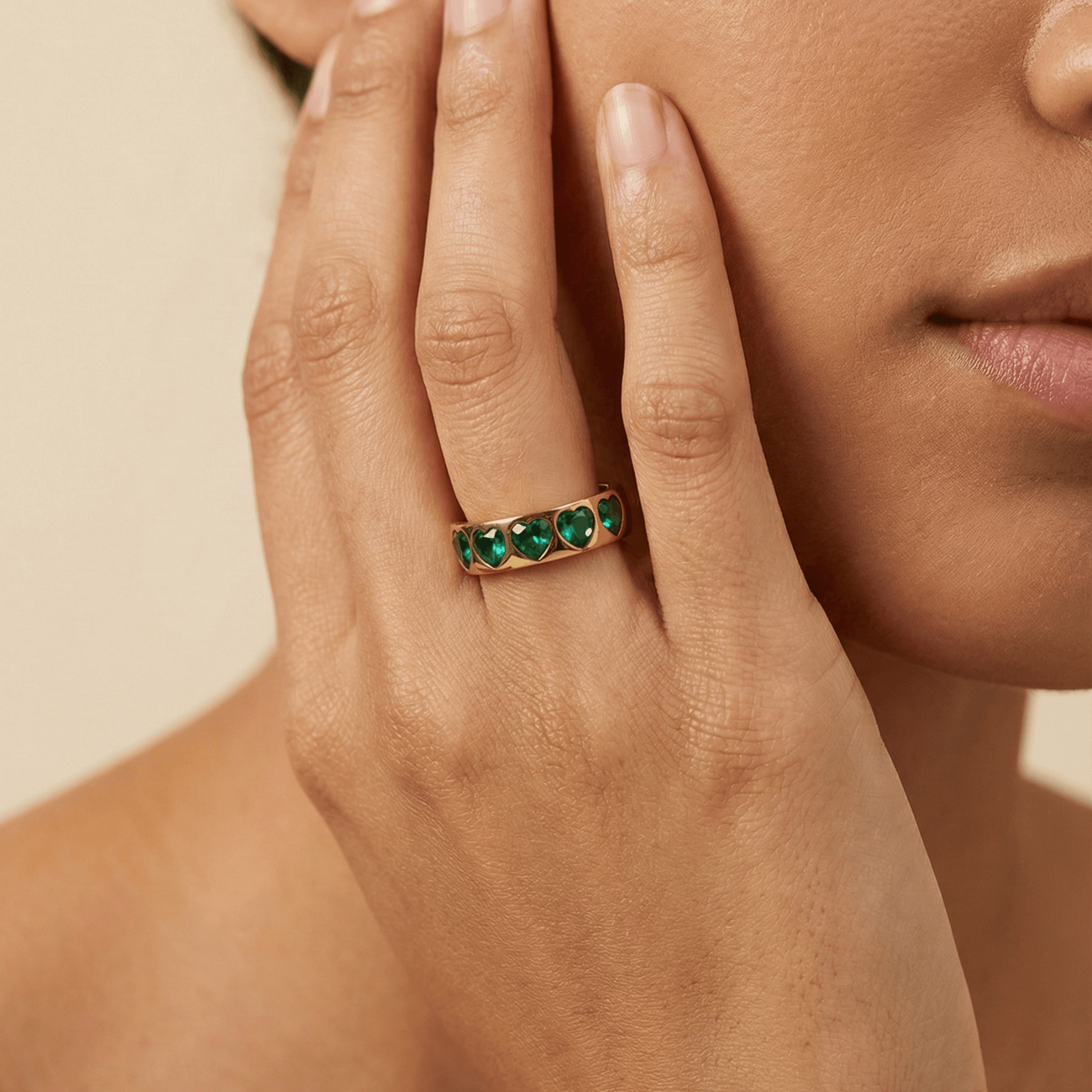Gold Emerald Green Heart Ring by MXW Jewellery featuring a chunky gold band with flush-set emerald-hued heart stones