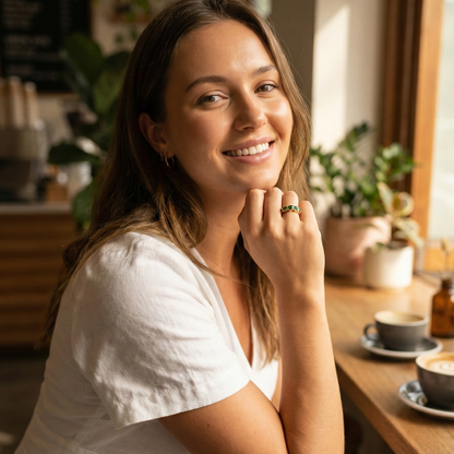 Gold Emerald Green Heart Ring by MXW Jewellery featuring a chunky gold band with flush-set emerald-hued heart stones