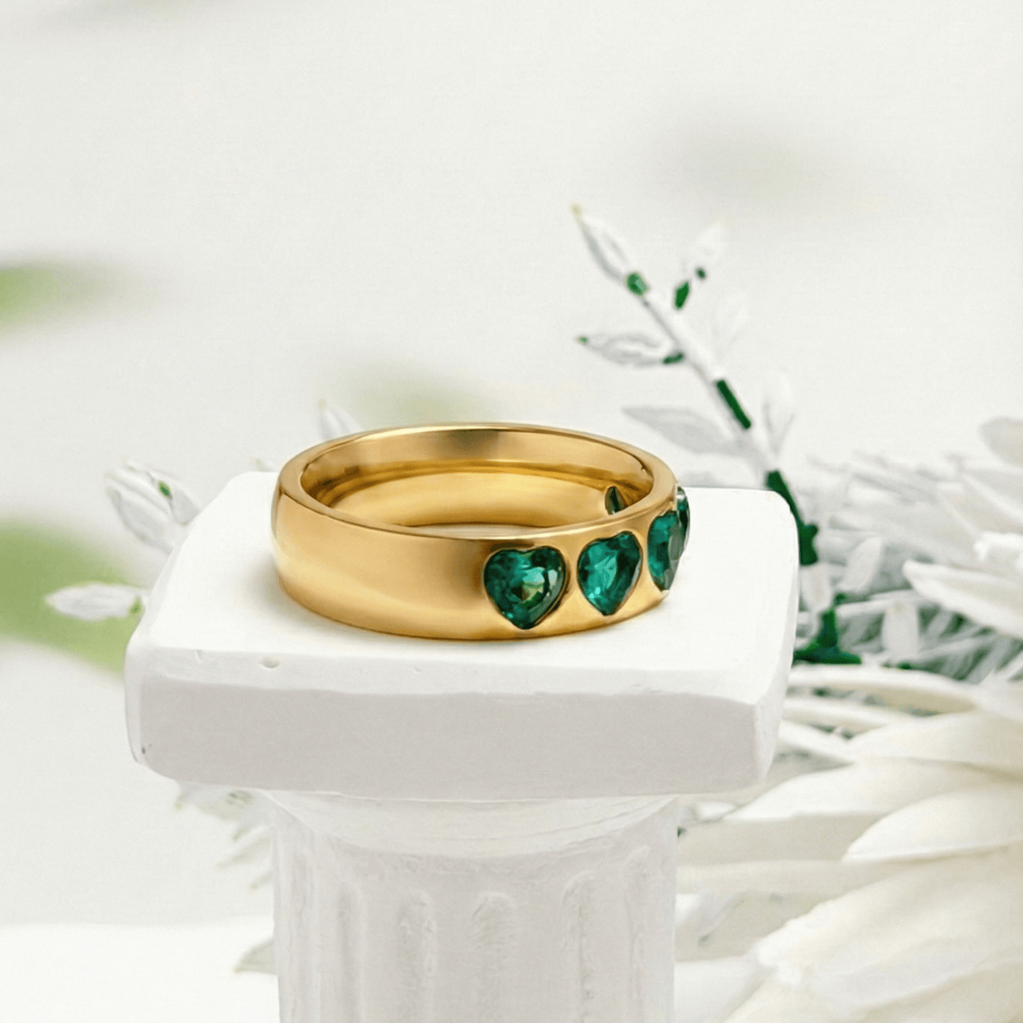 Gold Emerald Green Heart Ring by MXW Jewellery featuring a chunky gold band with flush-set emerald-hued heart stones