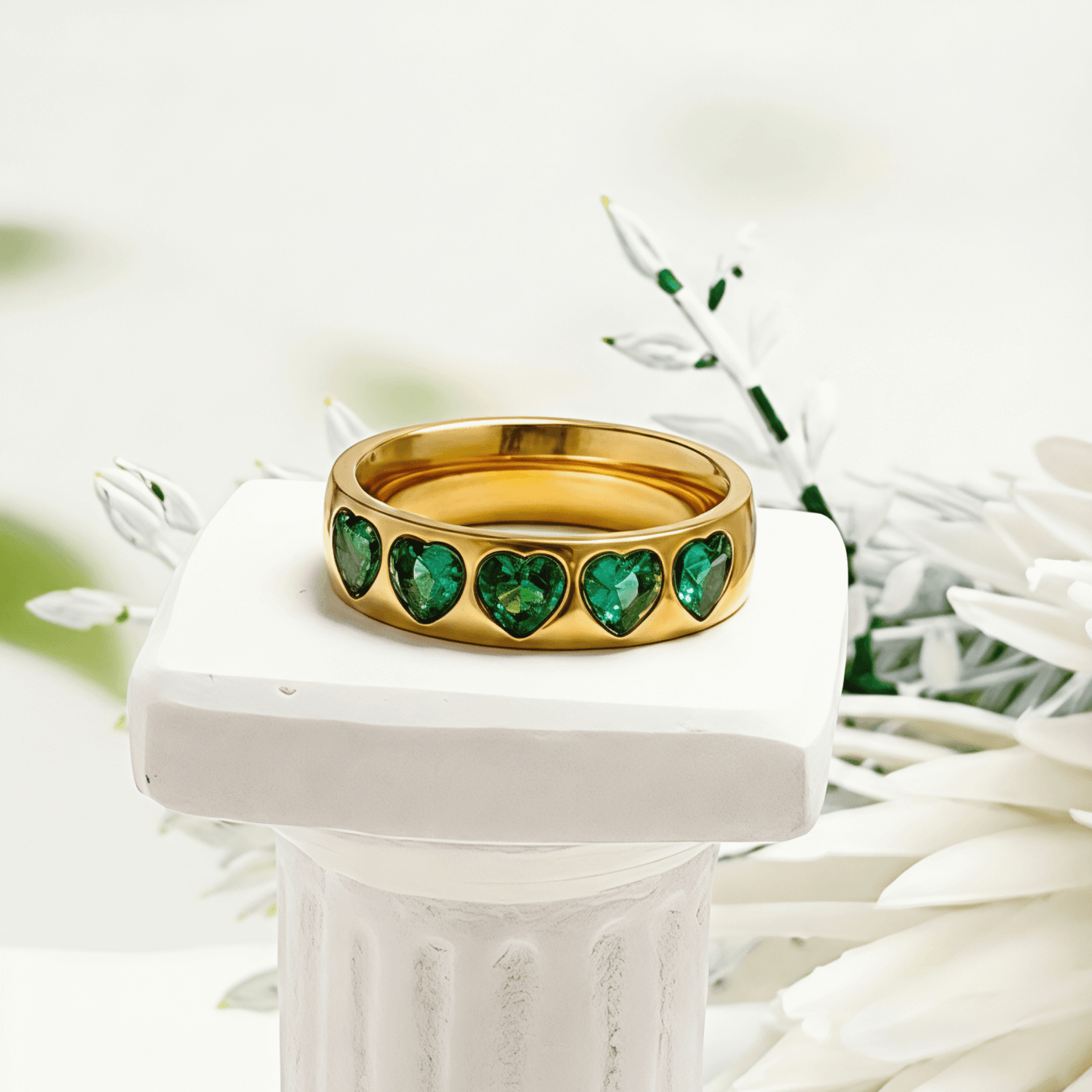 Gold Emerald Green Heart Ring by MXW Jewellery featuring a chunky gold band with flush-set emerald-hued heart stones